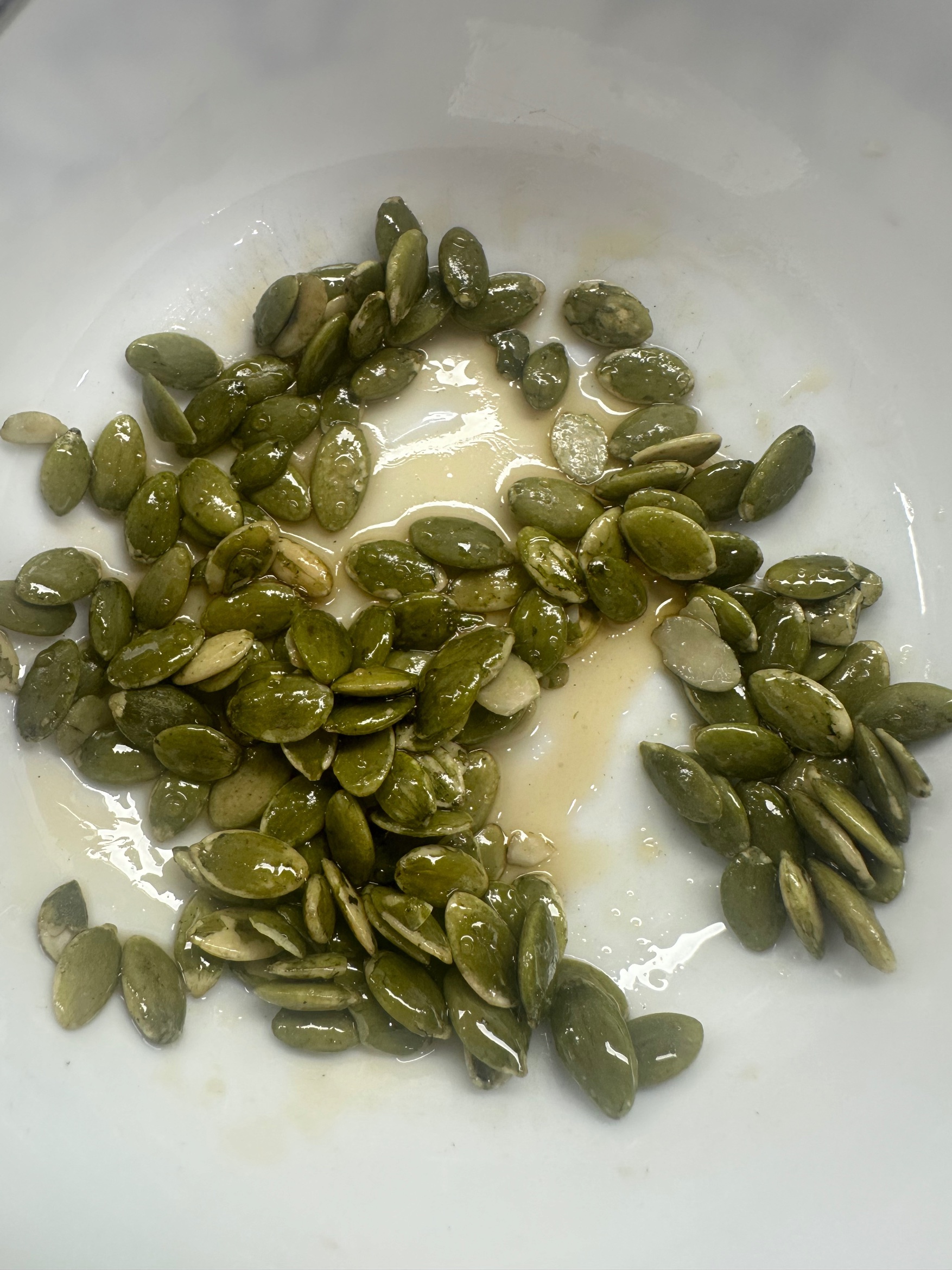Pepitas tossed in honey for pumpkin bread topping