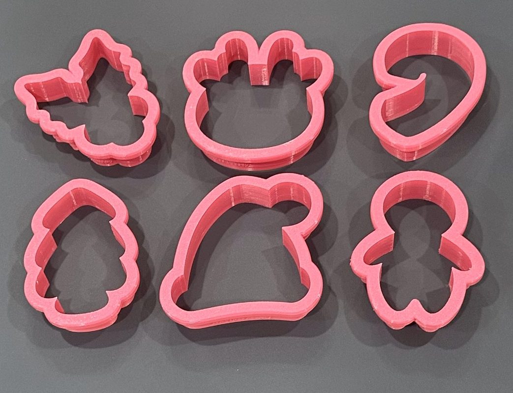 A set of pink 3D printed cookie cutters Kathy designed and printed at home