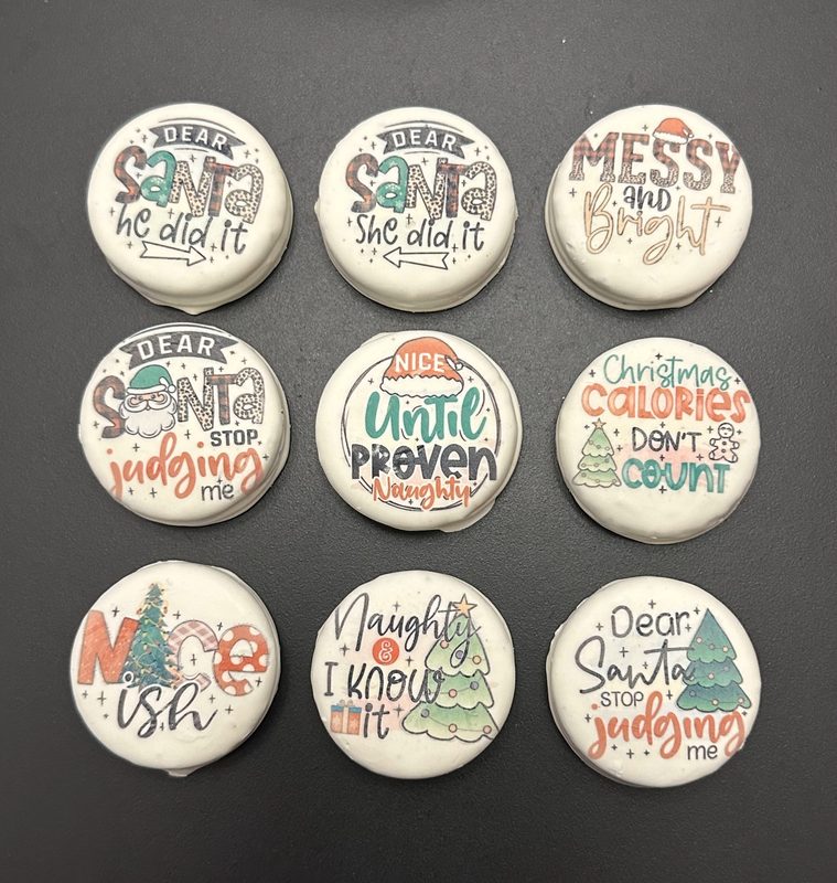 Nine white fudge Oreos printed on the Eddie with funny Christmas sayings like Dear Santa he did it, Christmas calories don't count, and Nice until proven naughty