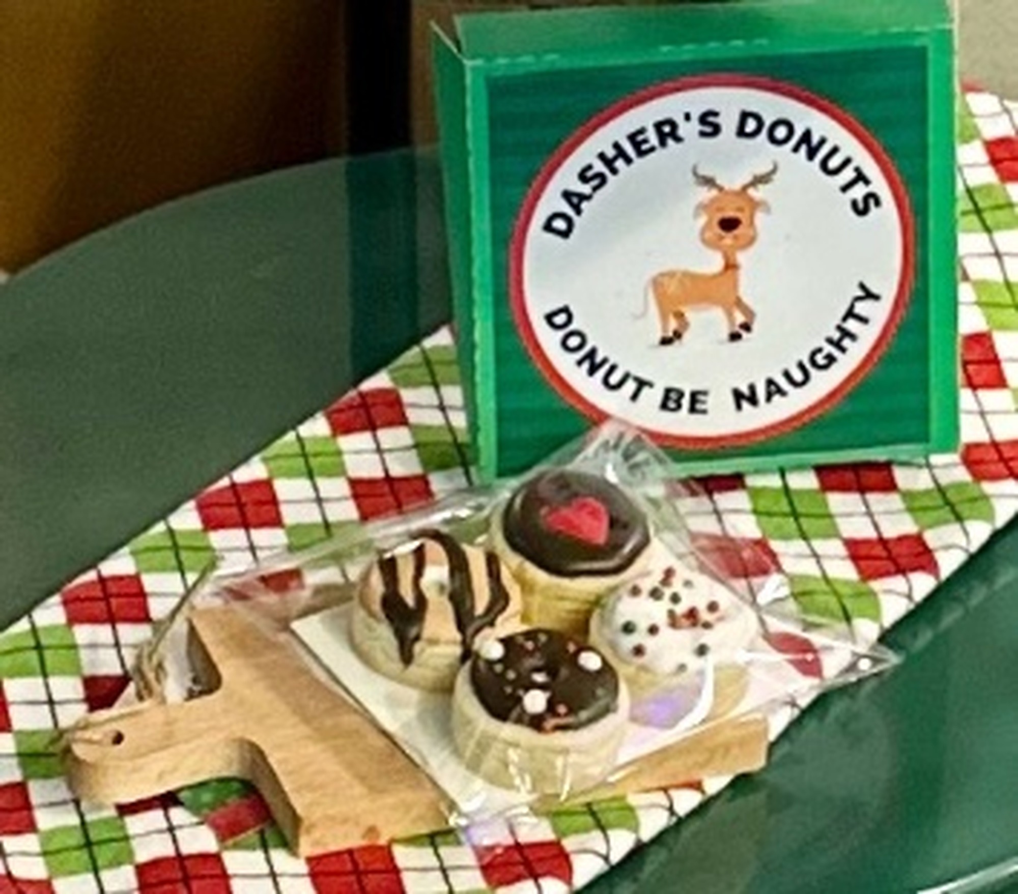 Green Dasher's Donuts box with sticker and mini donut cookies in a cello bag