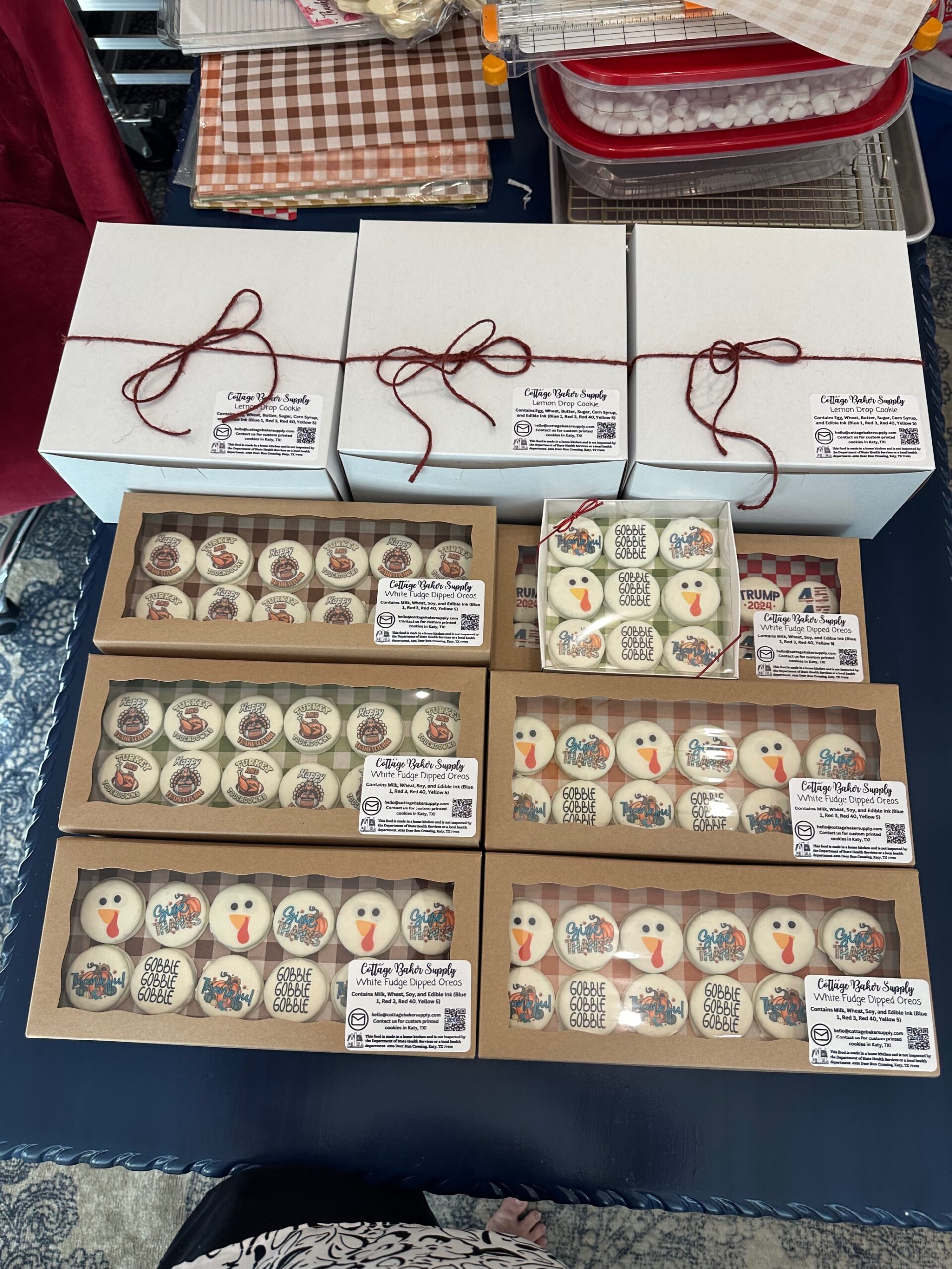 Finished Thanksgiving cookie orders in labeled boxes tied with twine