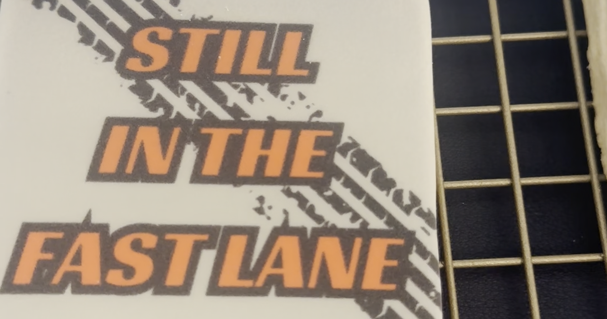 Eddie-printed 'Still in the Fast Lane' cookie on a cooling rack, printed on crusted royal icing