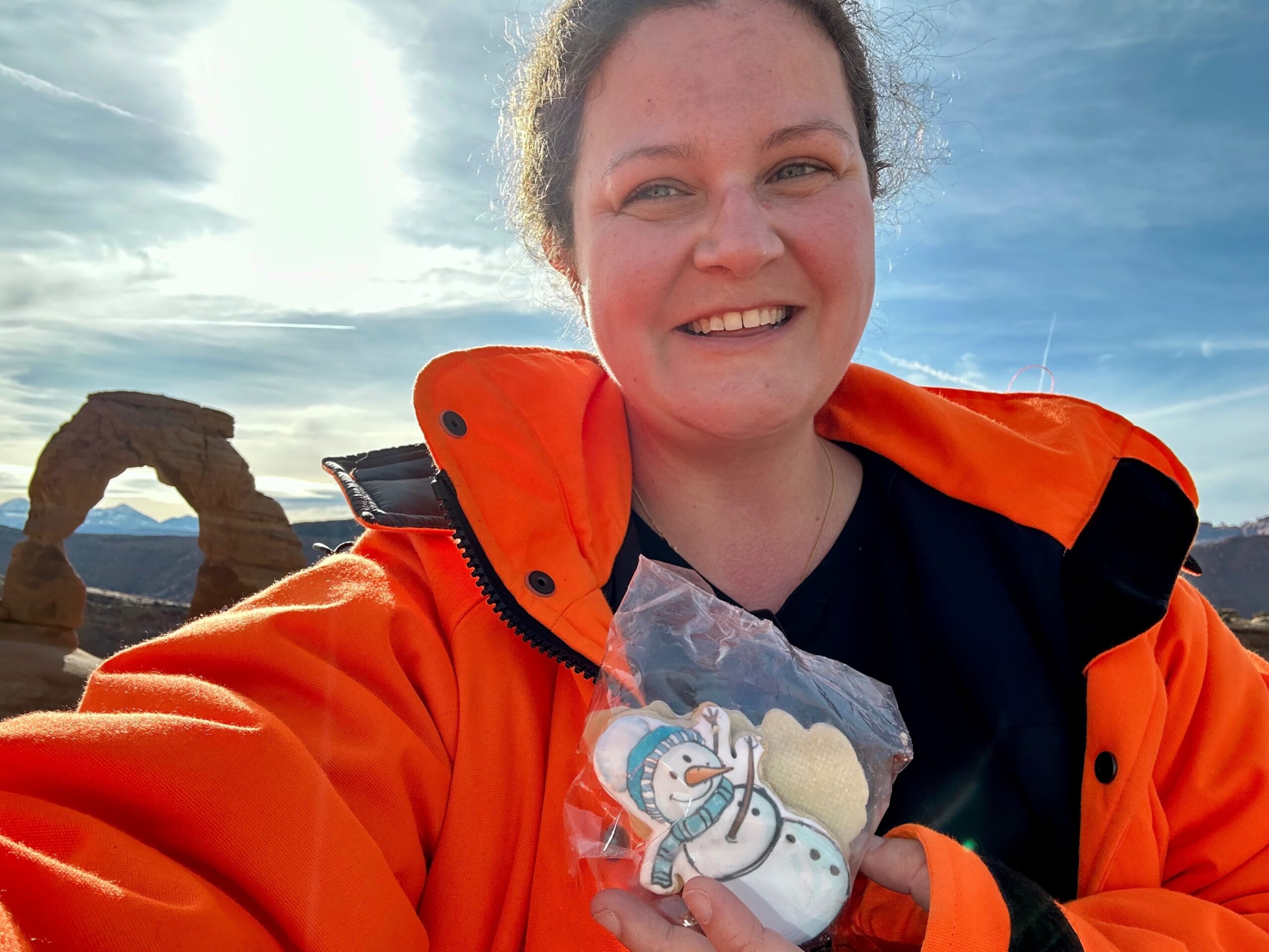 Kathy holding snowman cookie at Delicate Arch