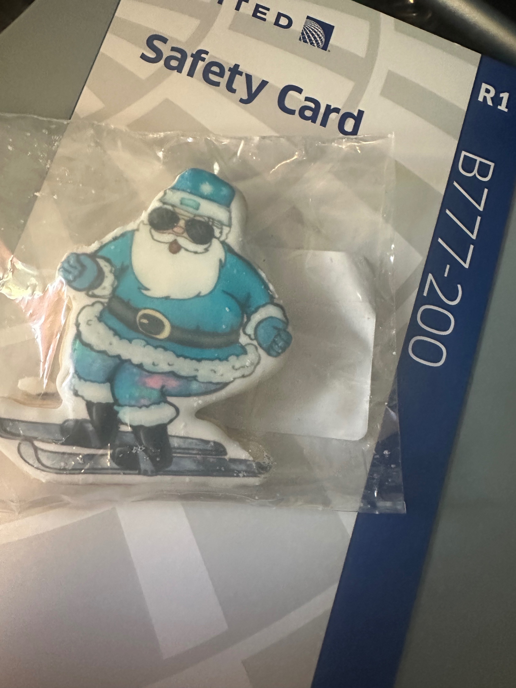 Ski Santa cookie on United Airlines safety card